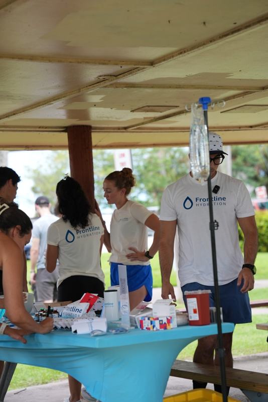 Frontline team working the event table next to an IV pole