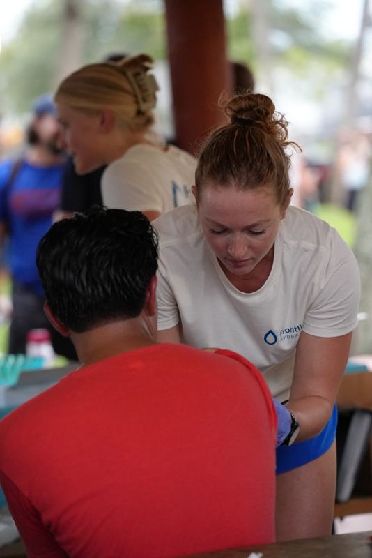 Provider giving an injection at a community event