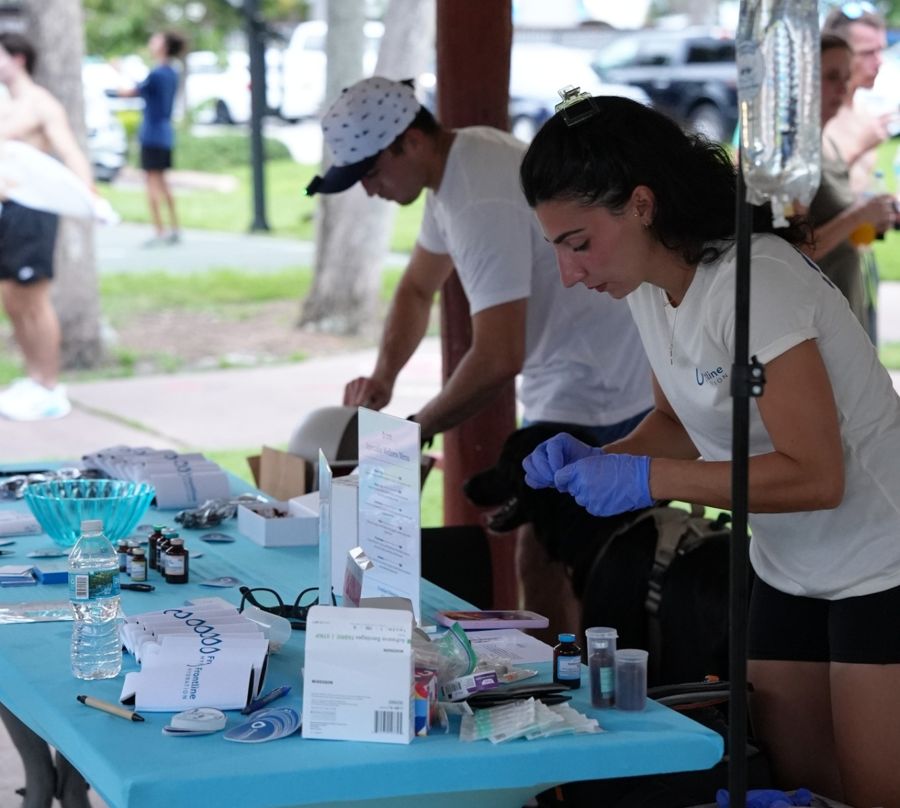 Frontline Hydration team preparing wellness shots at an outdoor community event